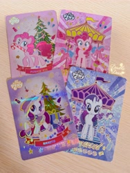 Size: 3955x5273 | Tagged: safe, pinkie pie, rarity, earth pony, pony, unicorn, g4, official, candy, candy cane, card, carousel, christmas, christmas tree, clothes, cutie mark, food, front view, holiday, horn, irl, looking at you, looking back, looking offscreen, merchandise, photo, present, side view, tree, walking, winter outfit