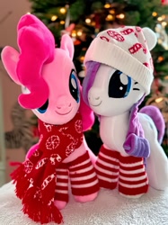 Size: 959x1280 | Tagged: safe, artist:symbiotestudios, pinkie pie, rarity, earth pony, pony, unicorn, g4, christmas, christmas socks, christmas tree, clothes, decoration, duo, female, hat, holiday, horn, indoors, irl, mare, photo, plushie, scarf, smiling, socks, standing, tree