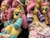 Size: 4032x3024 | Tagged: safe, artist:calusariac, artist:qtpony, fluttershy, pegasus, pony, rabbit, everfree northwest, g4, animal, badge, blanket, blue socks, blushing, clothes, convention, cute, everfree northwest 2024, flower, flower in hair, fluttergoth, heart, heart eyes, hoodie, irl, lanyard, multeity, photo, plush pile, plushie, purple socks, shyabetes, smiling, socks, striped socks, wingding eyes