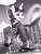 Size: 1662x2200 | Tagged: safe, artist:tsitra360, oc, oc:velocity, pony, unicorn, bounty hunter, city, clothes, female, giantess, grayscale, holding on, horn, hunting, levitation, looking down, macro, magic, monochrome, open mouth, raised hoof, shoes, teeth, telekinesis, tongue out, unicorn oc