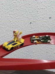 Size: 2448x3264 | Tagged: safe, artist:tom artista, fluttershy, pegasus, pony, g4, car, crossover, female, formula 1, hot wheels, indoors, kinder egg, pilot, race, race track, racecar, racing, side draft, toy, tracks, vehicle