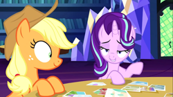 Size: 1394x783 | Tagged: safe, screencap, applejack, starlight glimmer, earth pony, pony, unicorn, every little thing she does, g4, season 6, duo, duo female, female, library, mare, shrunken pupils, twilight's castle, twilight's castle library
