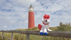 Size: 2016x1134 | Tagged: safe, oc, oc only, oc:stroopwafeltje, pony, collar, fence, irl, lighthouse, nation ponies, netherlands, photo, plushie, ponified, ponycon holland, solo, texel