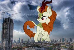 Size: 1599x1066 | Tagged: safe, artist:aeonkrow, edit, editor:jaredking779, autumn blaze, kirin, g4, attack on pony, bangkok, cloven hooves, eyebrows, female, giant pony, giantess, highrise ponies, irl, lidded eyes, macro, photo, ponies in real life, raised eyebrow, raised hoof, red eyes, smiling, solo, story included, thailand