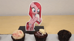 Size: 1920x1080 | Tagged: safe, ai assisted, ai content, artist:kopaleo, generator:pony diffusion v6 xl, generator:stable diffusion, prompter:kopaleo, pinkie pie, earth pony, pony, g4, animated, baking, bipedal, cupcake, female, food, frosting, hoof hold, irl, mare, mouth hold, photo, pinkamena diane pie, solo, stop motion, webm