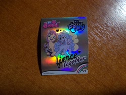 Size: 1024x768 | Tagged: safe, izzy moonbow, sunny starscout, earth pony, unicorn, g5, official, 2d, alarm, heart, horn, indonesian, looking at you, looking away, merchandise, photo, rainbow, shiny, slogan, smiling, smiling at you, sticker