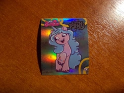 Size: 1024x768 | Tagged: safe, izzy moonbow, unicorn, g5, official, 2d, horn, indonesian, logo, looking away, merchandise, photo, raised hoof, shiny, smiling, standing, sticker