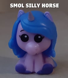 Size: 1203x1374 | Tagged: safe, izzy moonbow, pony, unicorn, g5, caption, horn, irl, merchandise, pencil topper, photo, text, toy