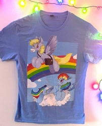 Size: 737x912 | Tagged: safe, artist:spookyfoxinc, derpy hooves, rainbow dash, pegasus, background, clothes, cloud, design, etsy, fan made, flying, mail, mailmare, merchandise, rainbow, shirt, t-shirt