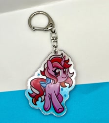 Size: 2250x2518 | Tagged: safe, artist:redpalette, galaxy (g1), unicorn, g1, bow, horn, keychain, looking at you, merchandise, photo, smiling