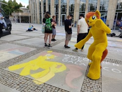 Size: 1280x960 | Tagged: safe, artist:atalonthedeer, artist:silou_atien, oc, oc:canni soda, human, galacon, 2022, chalk drawing, convention, fursuit, irl, irl human, outdoors, photo, ponysuit, traditional art