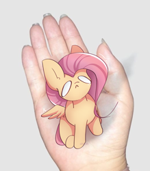 Size: 1997x2280 | Tagged: safe, artist:miryelis, fluttershy, human, pegasus, pony, g4, :<, crying, cute, disembodied hand, full body, hand, in goliath's palm, irl, irl human, meme, micro, photo, sitting, size difference, small pony, smol, solo