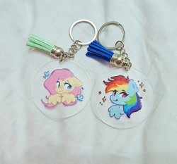 Size: 2491x2326 | Tagged: safe, artist:mirtash, fluttershy, rainbow dash, butterfly, pegasus, pony, g4, blue coat, colored pinnae, cute, dashabetes, duo, duo female, ear fluff, eye clipping through hair, eyebrows, eyebrows visible through hair, eyelashes, female, floppy ears, irl, keychain, looking at you, mare, multicolored hair, multicolored mane, one eyebrow raised, photo, pink eyes, pink mane, rainbow hair, raised eyebrow, shiny eyes, shyabetes, smiling, smiling at you, sparkles, wing fluff, wings, yellow coat