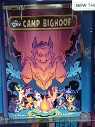 Size: 3000x4000 | Tagged: safe, bighoof, hitch trailblazer, izzy moonbow, misty brightdawn, pipp petals, sunny starscout, zipp storm, pegasus, pony, g5, spoiler:comic, bigfoot, book cover, bookshelf, bookstore, camp bighoof, campfire, cover, creature, fill, foal, hooves in air, irl, mane five, mane six (g5), night, photo