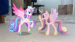 Size: 4032x2268 | Tagged: safe, gameloft, princess cadance, princess flurry heart, alicorn, pony, g4, my little pony: magic princess, 3d, 3d model, adult flurry heart, augmented reality, chair, crown, duo, female, funko, hoof shoes, irl, jewelry, looking at each other, looking at someone, mare, mother and child, mother and daughter, older, older flurry heart, peytral, photo, ponies in real life, raised hoof, regalia, rug, spread wings, toy, wings