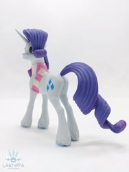 Size: 1620x2160 | Tagged: safe, alternate angle, alternate version, artist:lakterra, rarity, pony, unicorn, g4, butt, clothes, craft, female, figurine, horn, irl, mare, photo, plot, polymer clay, scarf, signature, simple background, smiling, solo, tail, unshorn fetlocks, white background