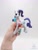Size: 1620x2160 | Tagged: safe, alternate angle, alternate version, artist:lakterra, rarity, human, pony, unicorn, g4, clothes, craft, female, figurine, hand, holding a pony, horn, irl, mare, photo, polymer clay, scarf, signature, simple background, striped scarf, tail, unshorn fetlocks, white background