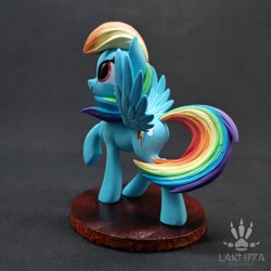 Size: 2560x2560 | Tagged: safe, alternate angle, alternate version, artist:lakterra, rainbow dash, pegasus, pony, g4, butt, craft, female, figurine, irl, looking up, mare, photo, plot, polymer clay, raised hoof, signature, smiling, solo, spread wings, stand, tail, three quarter view, wings