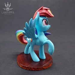Size: 2560x2560 | Tagged: safe, alternate angle, alternate version, artist:lakterra, rainbow dash, pegasus, pony, g4, craft, female, figurine, irl, looking up, mare, photo, polymer clay, raised hoof, side view, signature, smiling, solo, spread wings, stand, tail, wings