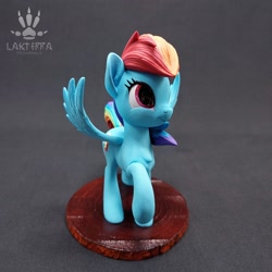 Size: 2560x2560 | Tagged: safe, alternate angle, alternate version, artist:lakterra, rainbow dash, pegasus, pony, g4, craft, female, figurine, irl, mare, photo, polymer clay, raised hoof, signature, smiling, solo, spread wings, stand, tail, wings