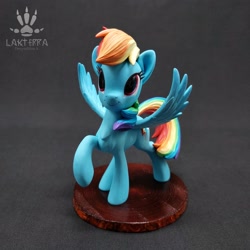 Size: 2560x2560 | Tagged: safe, alternate angle, alternate version, artist:lakterra, rainbow dash, pegasus, pony, g4, craft, female, figurine, irl, looking up, mare, photo, polymer clay, raised hoof, signature, smiling, solo, spread wings, stand, tail, wings