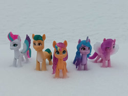 Size: 1032x774 | Tagged: safe, artist:dingopatagonico, hitch trailblazer, izzy moonbow, pipp petals, sunny starscout, zipp storm, earth pony, pegasus, unicorn, g5, horn, irl, mane five, mane stripe sunny, photo, snow, toy