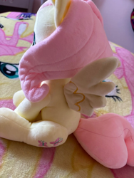 Size: 1500x2000 | Tagged: artist needed, safe, fluttershy, pegasus, pony, g4, blanket, craft, female, irl, mare, merchandise, photo, plushie, sitting, smiling, solo, spread wings, wings
