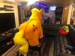 Size: 2048x1536 | Tagged: safe, applejack, g4, bookshelf, carpet, couch, fursuit, indoors, irl, nintendo switch, photo, pinball machine, ponysuit, quadsuit, rear view, scissors, solo, spookyjack, table, television