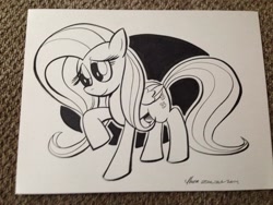 Size: 1024x768 | Tagged: safe, artist:thom zahler, fluttershy, pegasus, pony, g4, 2014, black and white, commission, female, folded wings, grayscale, heroescon, heroescon 2014, mare, monochrome, photo, raised hoof, smiling, solo, tail, traditional art, wings