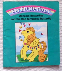 Size: 526x600 | Tagged: safe, dancing butterflies, butterfly, pegasus, pony, g1, official, book, book cover, bow, cover, dancing butterflies and the bad-tempered butterfly, female, mare, solo, tail, tail bow
