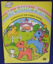 Size: 823x1000 | Tagged: safe, applejack (g1), bubbles (g1), earth pony, pony, g1, official, a shock at the stable show, book, book cover, bow, cover, female, flower, mare, tail, tail bow, trophy
