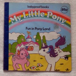 Size: 603x599 | Tagged: safe, applejack (g1), glory, locket (g1), earth pony, pegasus, pony, unicorn, g1, official, book, book cover, bow, cover, female, flower, fun in pony land, horn, mare, stable, tail, tail bow, trio, trio female
