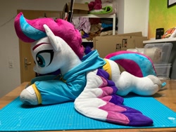 Size: 1280x960 | Tagged: safe, artist:melodis, artist:melodisde, zipp storm, pegasus, pony, g5, clothes, colored wings, female, hoodie, irl, life size, lying down, mare, multicolored wings, photo, plushie, solo, unshorn fetlocks, wings