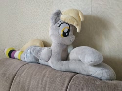 Size: 1080x810 | Tagged: safe, artist:percypawz, derpy hooves, pegasus, pony, g4, clothes, couch, crossed hooves, female, lying down, mare, nonbinary, nonbinary pride flag, photo, plushie, pride, pride flag, socks, solo, striped socks, toy