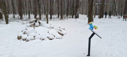 Size: 4080x1830 | Tagged: safe, artist:kuba18i, rainbow dash, pegasus, pony, tortoise, g4, female, irl, outdoors, photo, plushie, poland, ponies around the world, ponies in real life, pony plushie, snow, solo, sosnowiec, statue