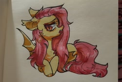 Size: 1080x729 | Tagged: safe, artist:vensual99, fluttershy, bat pony, pony, g4, bat ponified, ear tufts, fangs, female, flutterbat, lying down, mare, prone, race swap, simple background, slit pupils, solo, tongue out, traditional art, white background