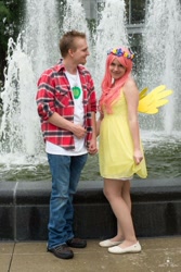 Size: 684x1024 | Tagged: safe, big macintosh, fluttershy, human, g4, 2015, clothes, cosplay, costume, cutie mark on clothes, denim, dress, duo, duo male and female, female, floral head wreath, flower, fountain, holding hands, irl, irl human, jeans, looking at you, male, pants, photo, plaid shirt, ship:fluttermac, shipping, shirt, shoes, smiling, smiling at you, straight, t-shirt, wig, wings