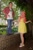 Size: 684x1024 | Tagged: safe, big macintosh, fluttershy, human, g4, 2015, brick wall, clothes, cosplay, costume, cutie mark on clothes, denim, dress, duo, duo male and female, female, floral head wreath, flower, hand on hip, holding hands, irl, irl human, jeans, looking at you, male, outdoors, pants, photo, plaid shirt, ship:fluttermac, shipping, shirt, shoes, shrug, straight, t-shirt, tree, wig, wings