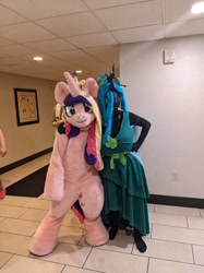 Size: 990x1321 | Tagged: safe, artist:chrysaltits, artist:qtpony, artist:zizzydizzymc, alicorn, changeling, changeling queen, backpack, duo, fight, fursuit, irl, photo, ponysuit