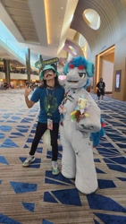 Size: 900x1599 | Tagged: safe, artist:springbear452_, oc, oc:the living tombstone, earth pony, human, 2023, clothes, cosplay, costume, duo, fursuit, headphones, indoors, irl, irl human, megaplex, photo, ponysuit