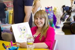 Size: 640x427 | Tagged: safe, fluttershy, human, pegasus, pony, g4, andrea libman, bottle, drawing, female, grin, irl, irl human, looking at you, photo, smiling, toy art gallery, voice actor