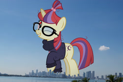 Size: 2048x1365 | Tagged: safe, artist:jhayarr23, edit, editor:jaredking779, moondancer, pony, unicorn, g4, alternate eye color, attack on pony, clothes, evil, female, florida, giant pony, giantess, glasses, grin, highrise ponies, horn, irl, long description, looking at you, macro, mare, miami, one eye closed, photo, ponies in real life, raised hoof, smiling, solo, story included, sweater, vulgar description, wink, winking at you, wrong eye color