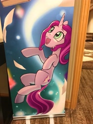 Size: 3024x4032 | Tagged: photographer needed, source needed, safe, artist:nadnerbd, oc, oc only, oc:novella, pony, unicorn, everfree northwest, banner, convention, convention art, cute, everfree northwest 2024, female, horn, hotel room, irl, mare, ocbetes, open mouth, photo, smiling, teenager, thin