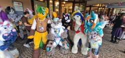 Size: 1280x598 | Tagged: safe, artist:atalonthedeer, artist:camillebunbun, oc, oc only, oc:bronycars, oc:eagle fly, oc:phoenix redtail, galacon, 2024, convention, furry, fursuit, group photo, irl, photo, ponysuit