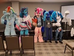 Size: 2048x1536 | Tagged: safe, dj pon-3, misty brightdawn, pinkie pie, rainbow dash, vinyl scratch, oc, oc:water wings, g5, 2024, fursuit, group photo, indoors, irl, photo, ponysuit, whinny city pony con