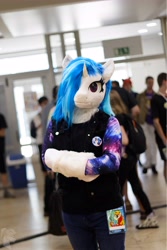 Size: 3648x5472 | Tagged: safe, artist:essorille, artist:vinylpone, dj pon-3, vinyl scratch, human, original species, plush pony, unicorn, anthro, g4, animal costume, arm hooves, blue mane, clothes, convention, cosplay, costume, cute, czequestria, equine, female, furry, fursuit, hooves, horn, indoors, irl, irl human, mare, messy mane, photo, plushie, ponysuit, public, purple eyes, ruffled hair, shirt, solo