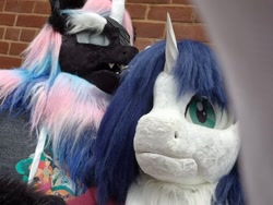 Size: 1280x960 | Tagged: safe, oc, oc only, oc:light, oc:noir, kirin, nirik, unicorn, brick wall, duo, fursuit head, horn, indoors, irl, photo, ponysuit, selfie