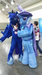 Size: 540x960 | Tagged: safe, artist:atalonthedeer, artist:judhudson, princess luna, trixie, human, g4, cape, clothes, duo focus, fursuit, hat, indoors, irl, irl human, jewelry, photo, ponysuit, regalia, trixie's cape, trixie's hat