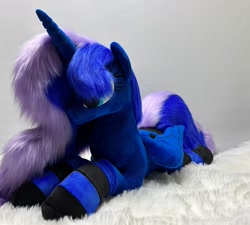 Size: 1280x1150 | Tagged: safe, artist:melodis, princess luna, alicorn, pony, g4, clothes, folded wings, irl, lying down, photo, plushie, prone, socks, solo, striped socks, wings