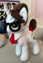 Size: 1428x2048 | Tagged: safe, artist:lilmoon, part of a set, raven, pony, unicorn, g4, brown eyes, brown mane, clothes, commission, commissioner:pony4koma, cute, female, glasses, hair bun, horn, irl, mare, necktie, photo, plushie, pony plushie, ravenbetes, secretary, tail, tail bun, white coat